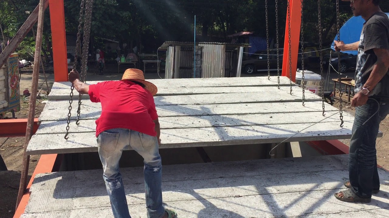 Concrete planks installing on steel structure at the construction site