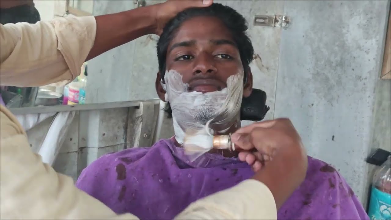 Boy beard first shave with straight razor