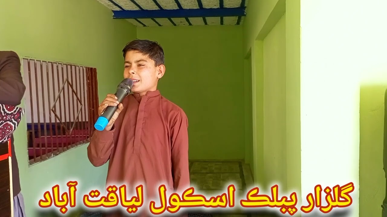 A fifth-grade student, Ghulam Hussain Rind, is reading rhymes in the Balochi language.