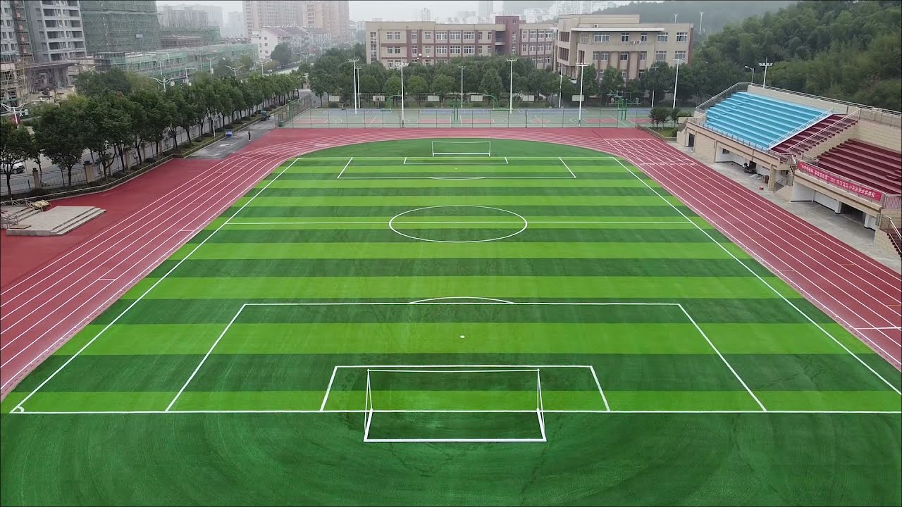 Sandwich system running track construction and Artificial turf pitch laying process