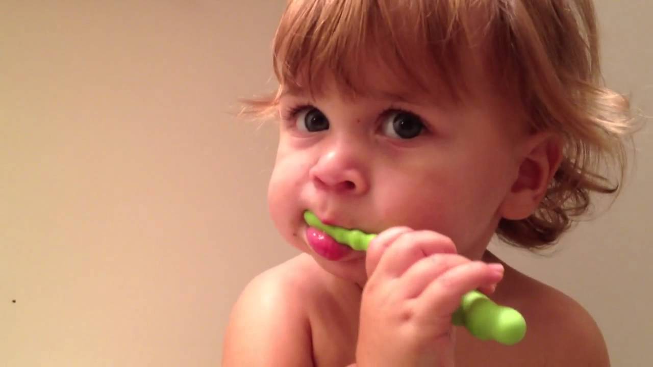 Baby brushes his teeth