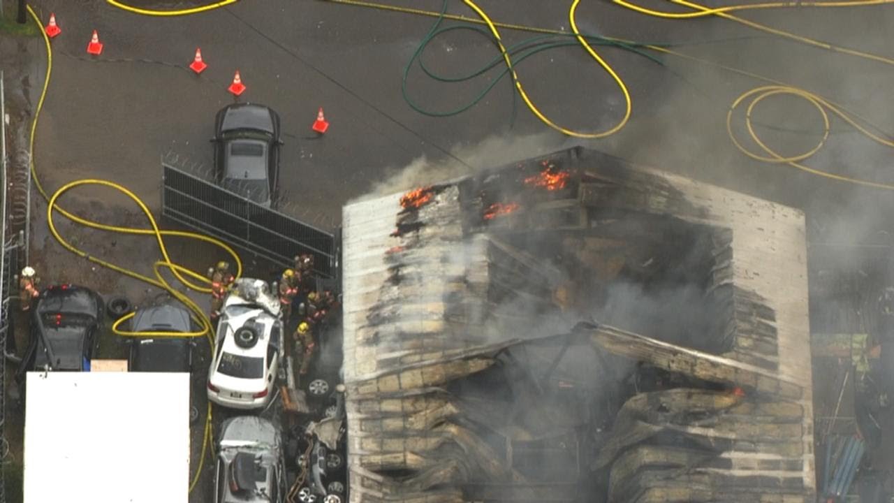 Crews battle two-alarm fire at auto wrecking shop in Gresham