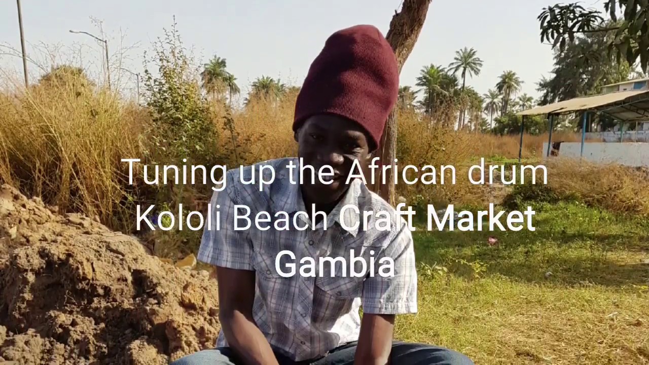 Tuning an African Drum Bongo Kololi Beach Craft Market Senegambia Gambia
