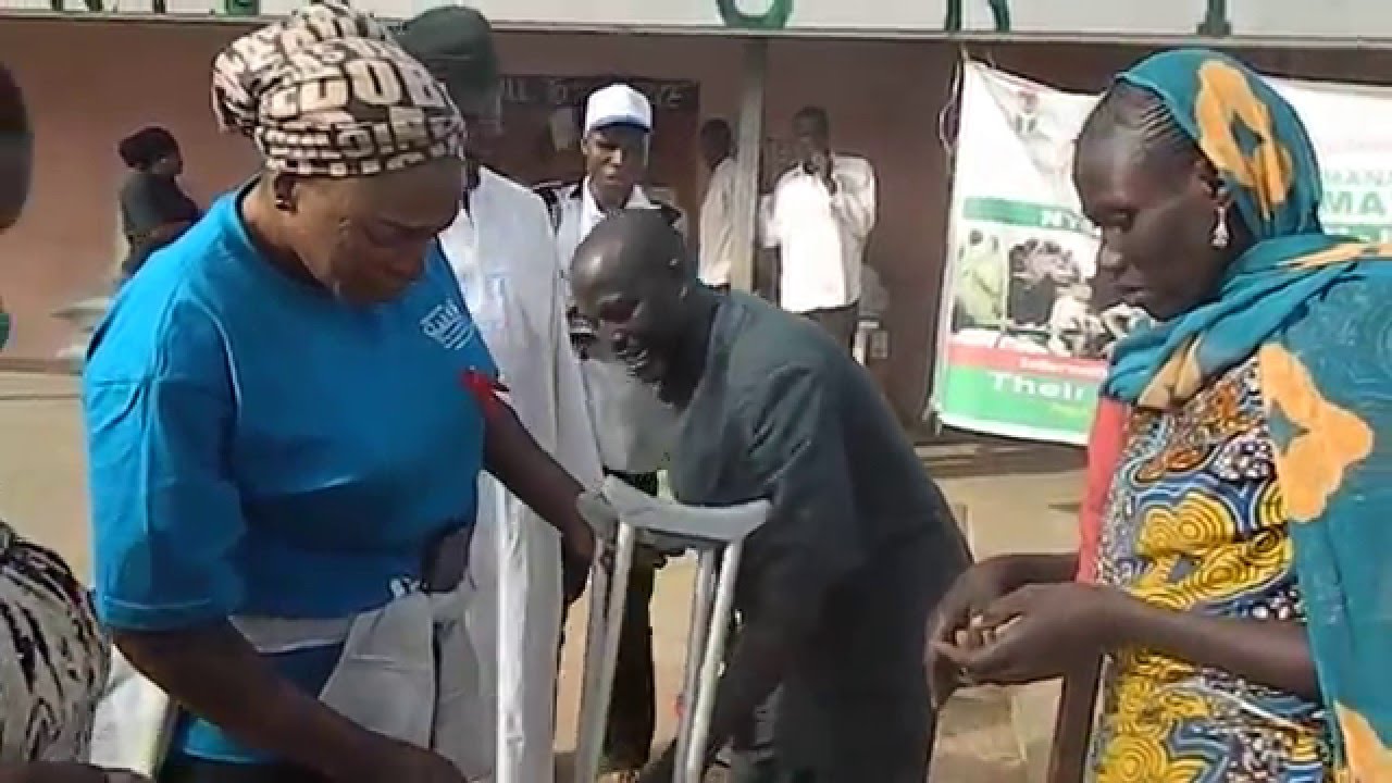 A woman recieving crutches at the Yola IDP camp