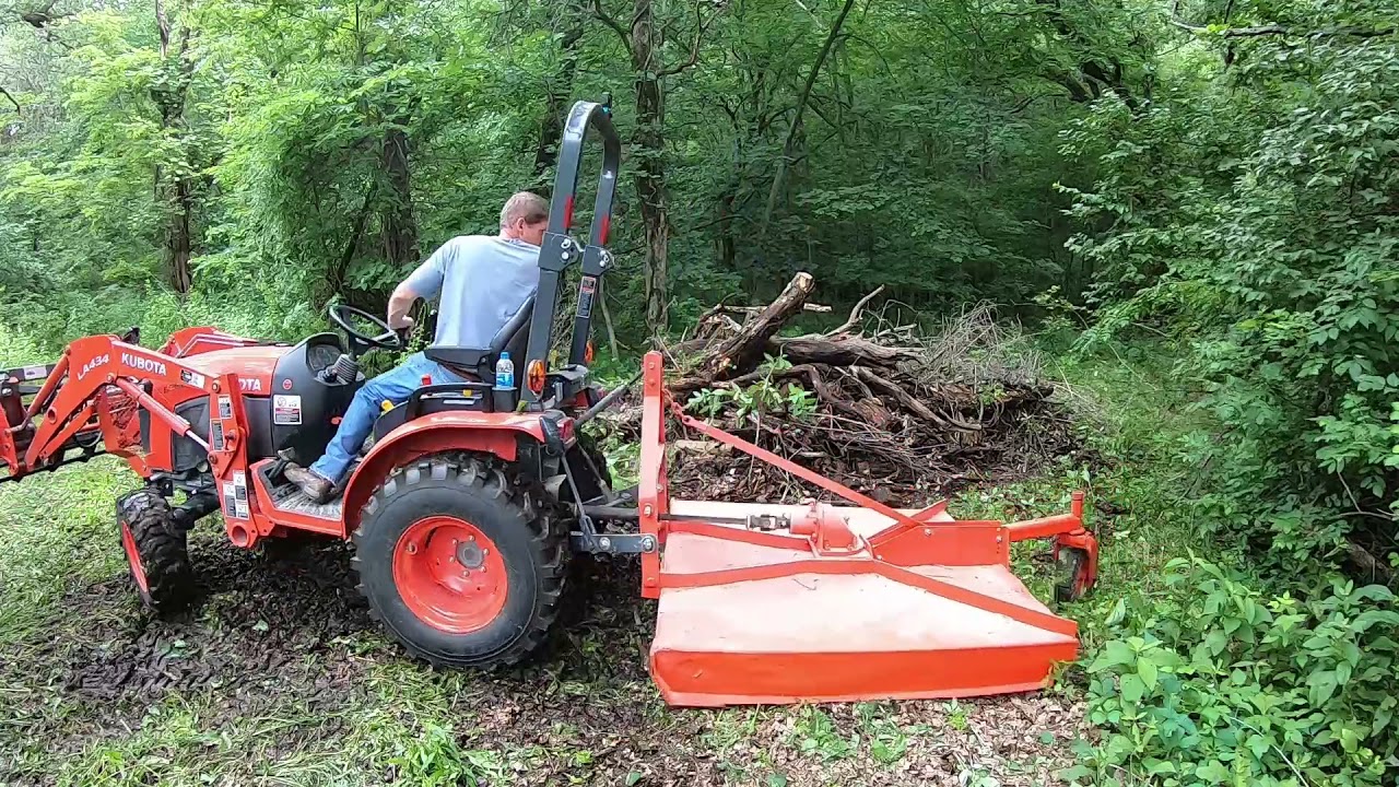 Kubota B2601 bush hogging overgrown septic field + dead tree removal