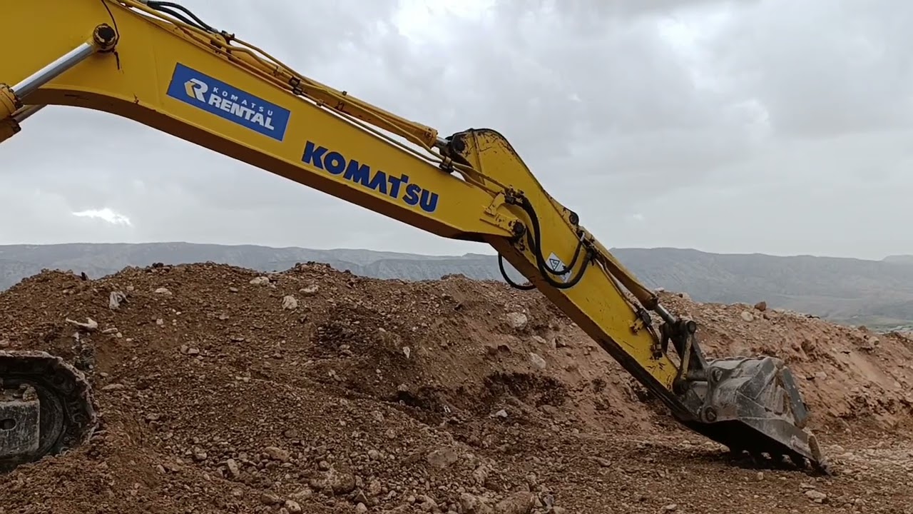 Leveling the road with an excavator 