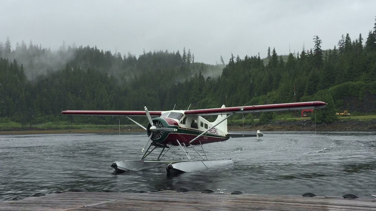 DeHavilland beaver taking off in Alaska. With another coming into the dock.