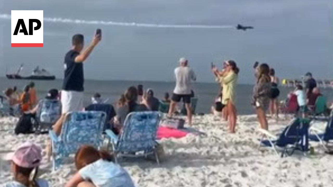 Video shows a fighter jet flying low over a crowded beach in Florida