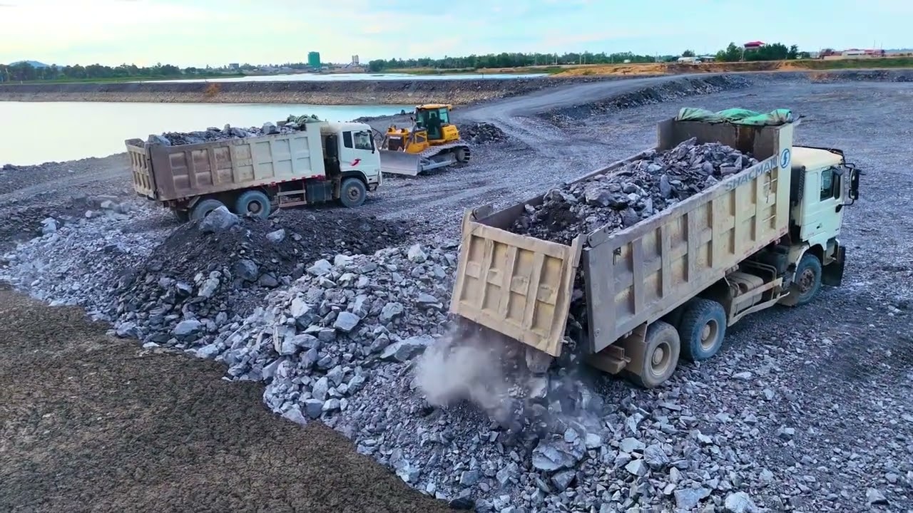 EP02,New development Starting a new road project with a dump truck being pushed by proficient dozer