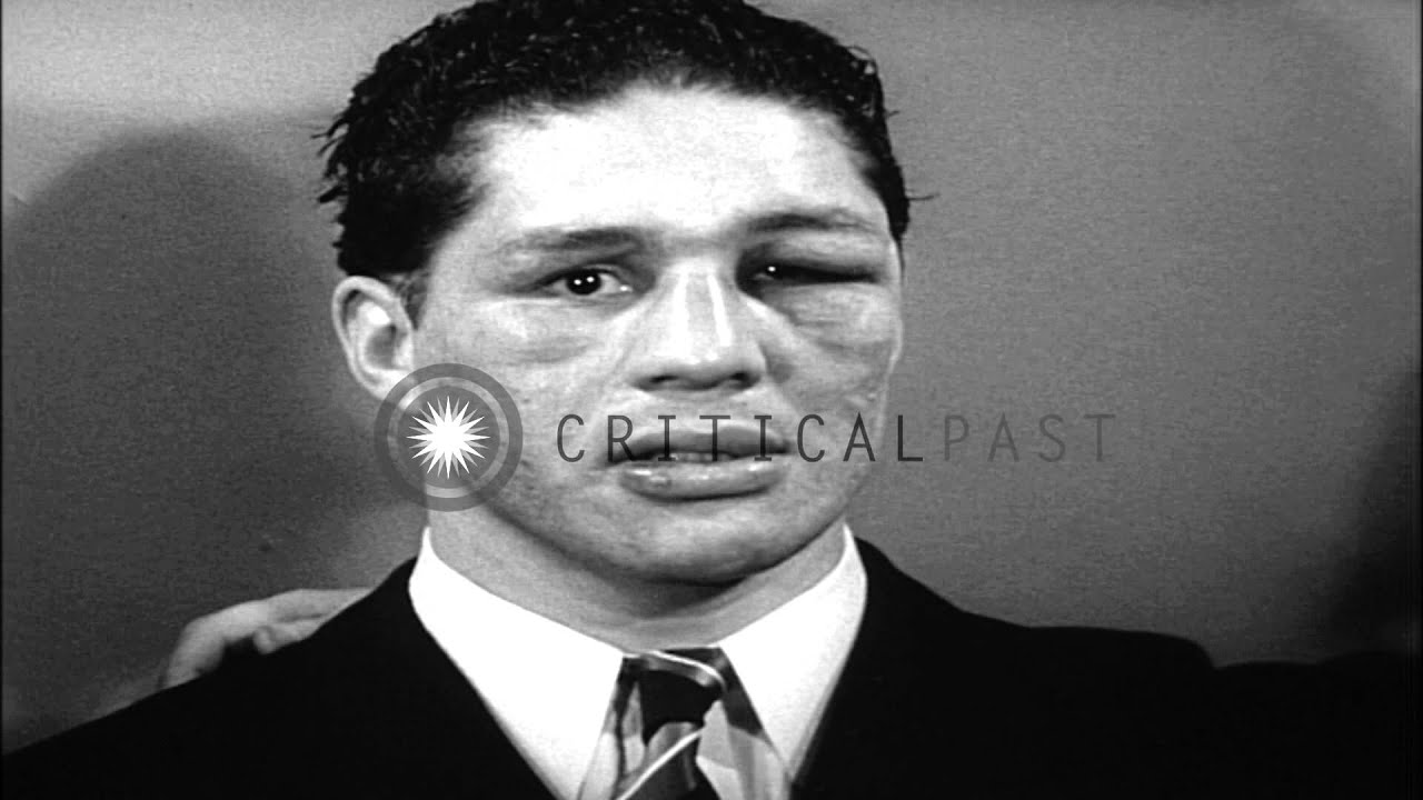 Chilean boxer Arturo Godoy wins a boxing match against Joe Louis and men take pic...HD Stock Footage