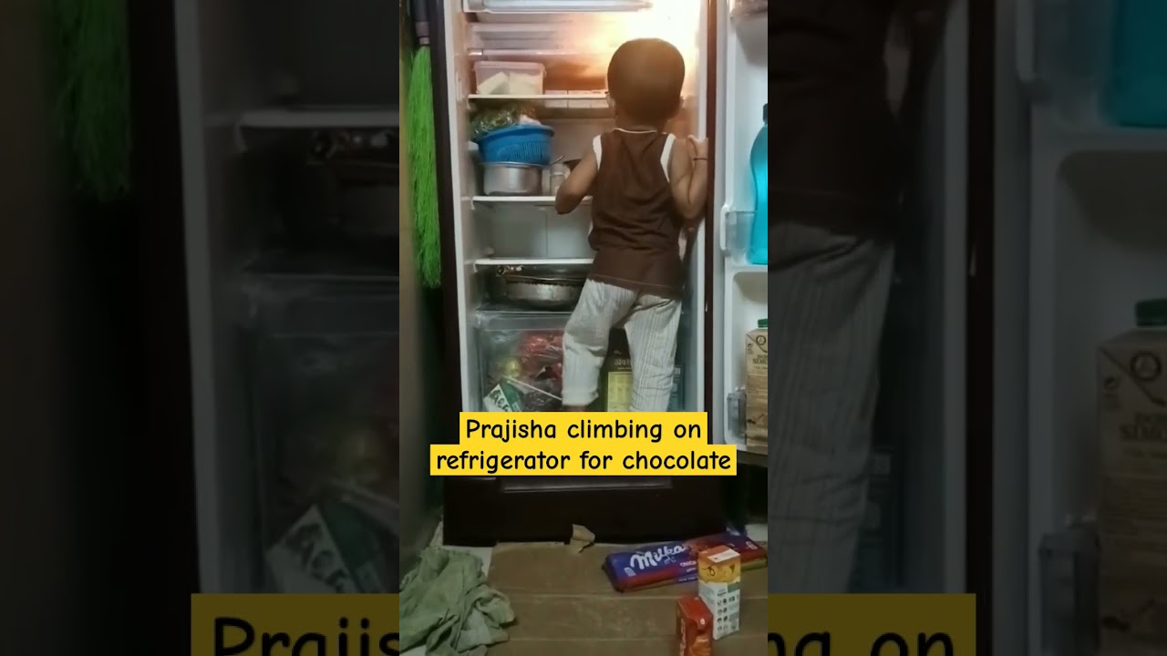 Baby climbing on refrigerator for chocolate | Prajisha playing #babymoments #shortsfeed #shorts