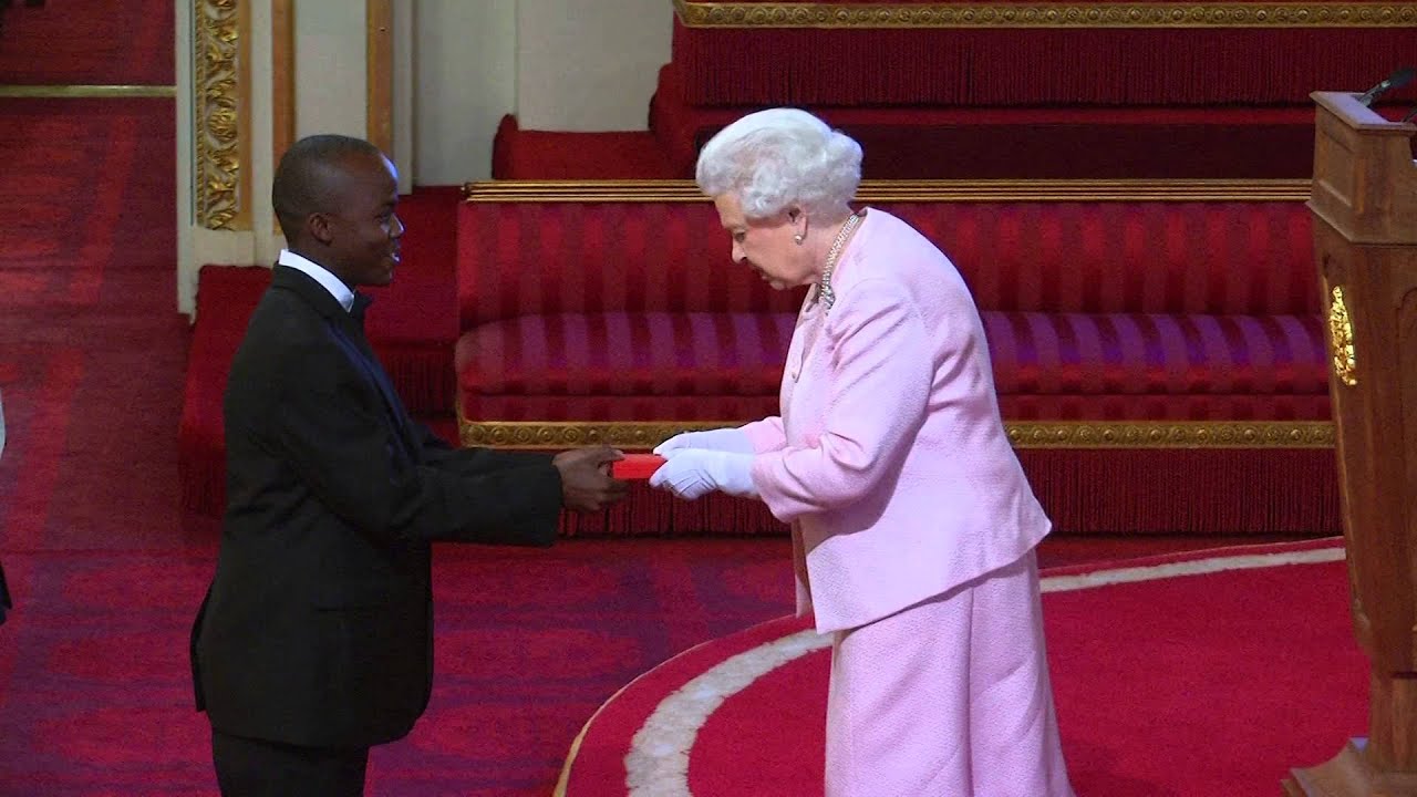 Given Edward receiving  an award from Her Majesty Queen Elizabeth II at Buckingham Palace, London
