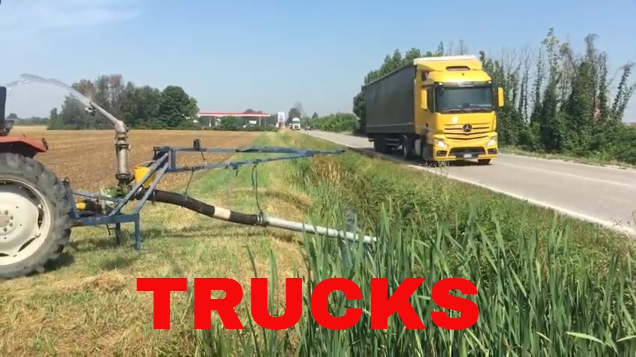 Trucks on the road and irrigation fields