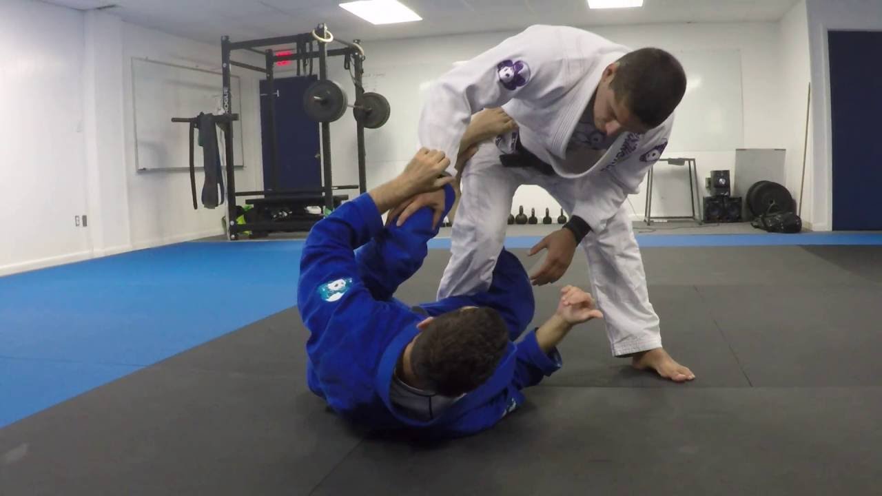 Quarter guard and reverse de la Riva guard when defending knee slice pass