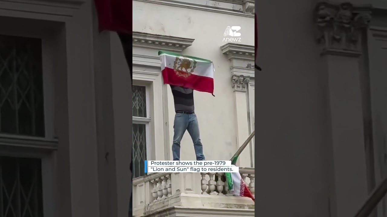 Protester tears down Iranian flag at embassy in London