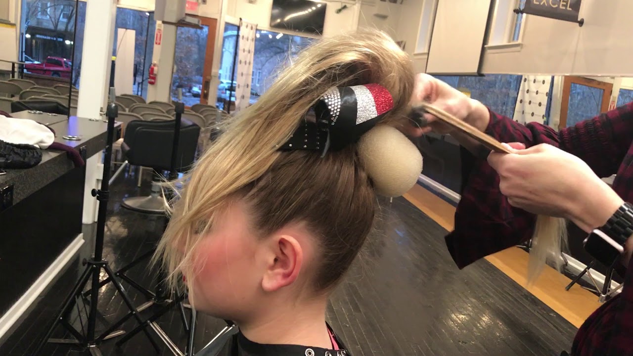 Cheer ponytail sits above bow