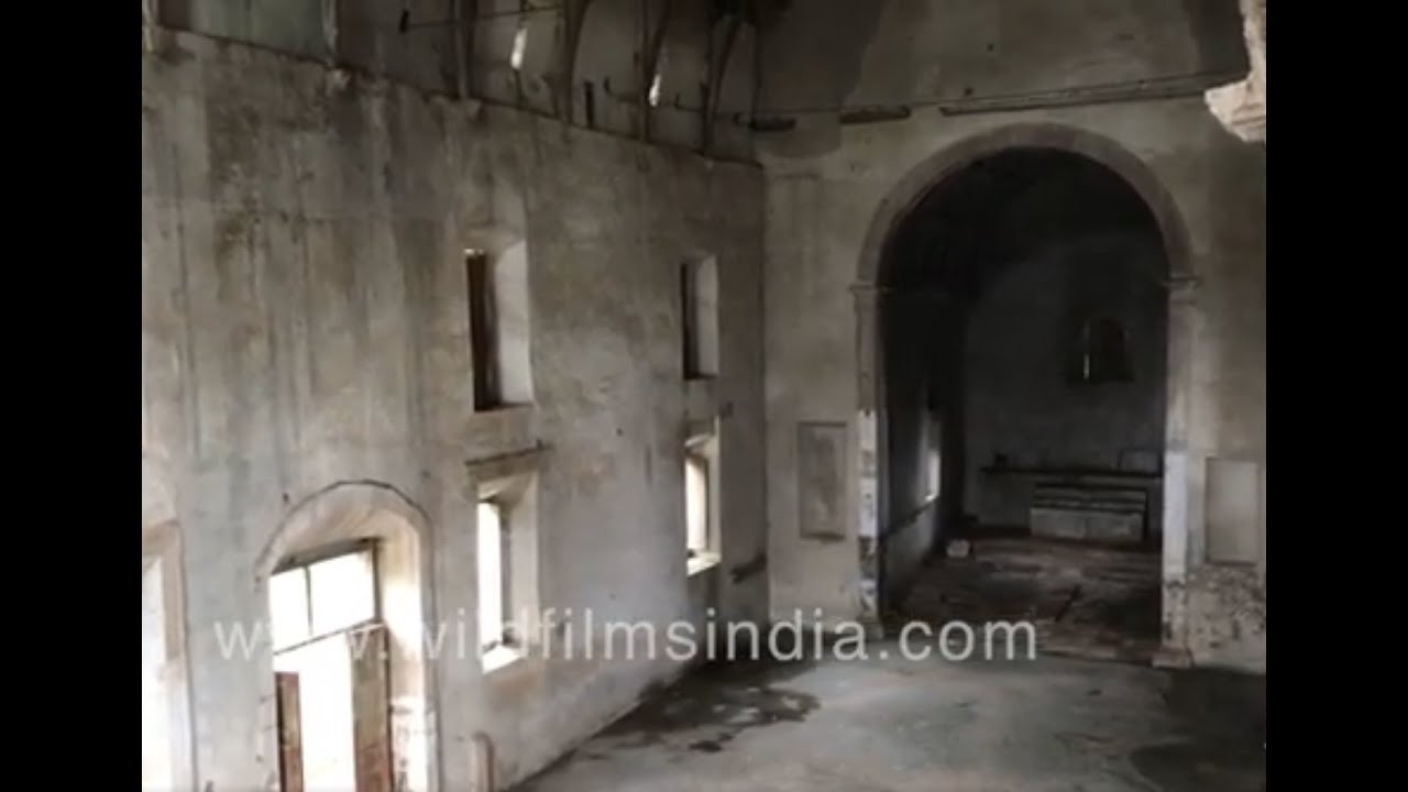 Ruins of churches inside Vasai Fort or Bassein Fort overrun with vegetation in monsoon