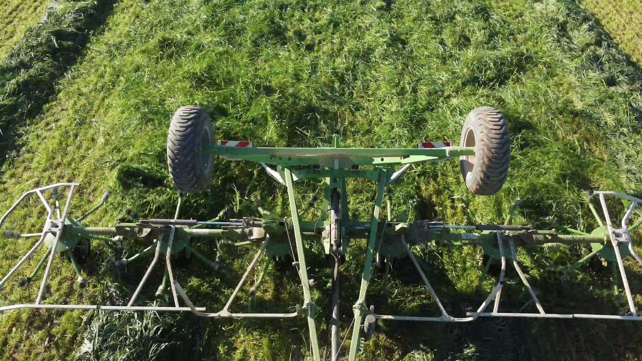 John Deere 6125R with Samasz P6 771 trailing tedder