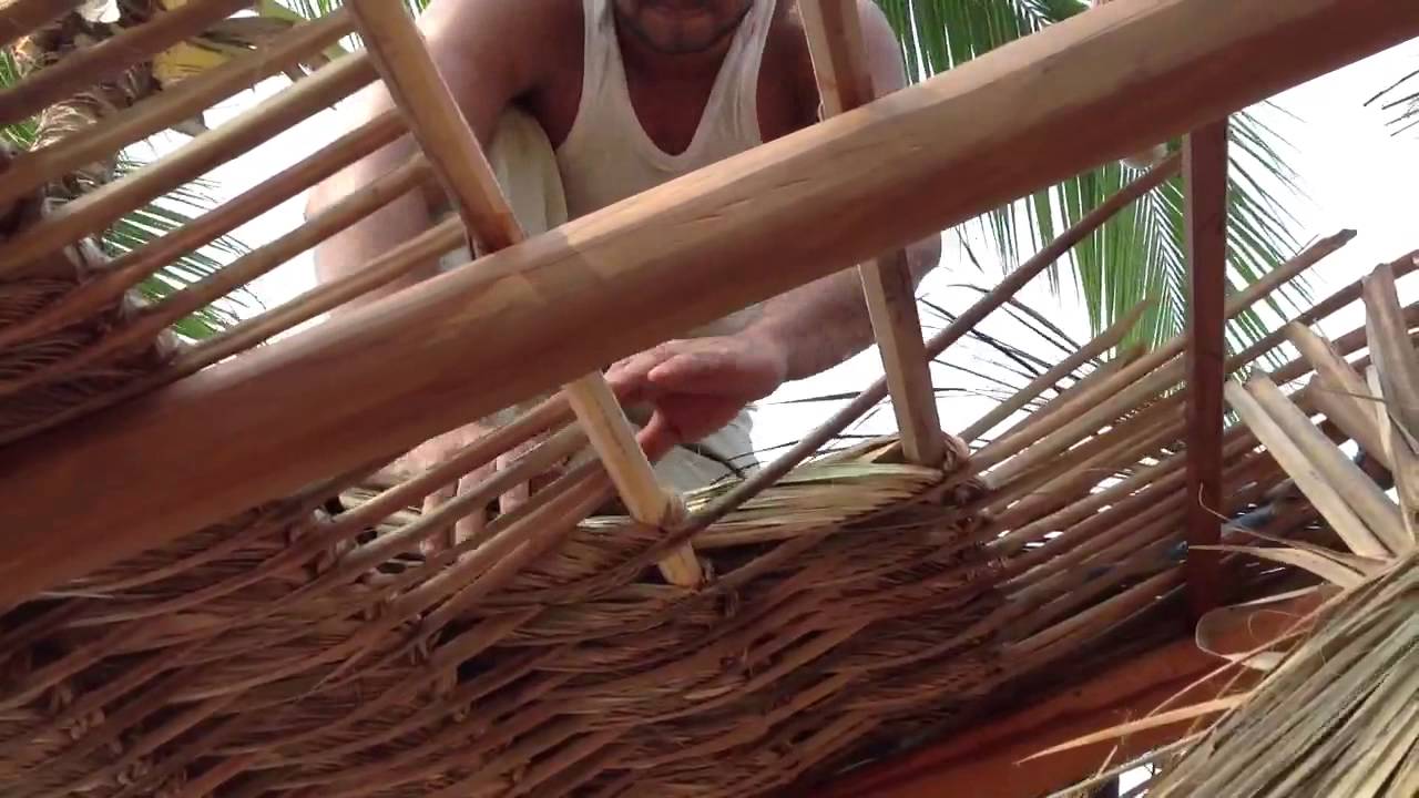 Tying the Royal Palm leaves to our Palapa roof