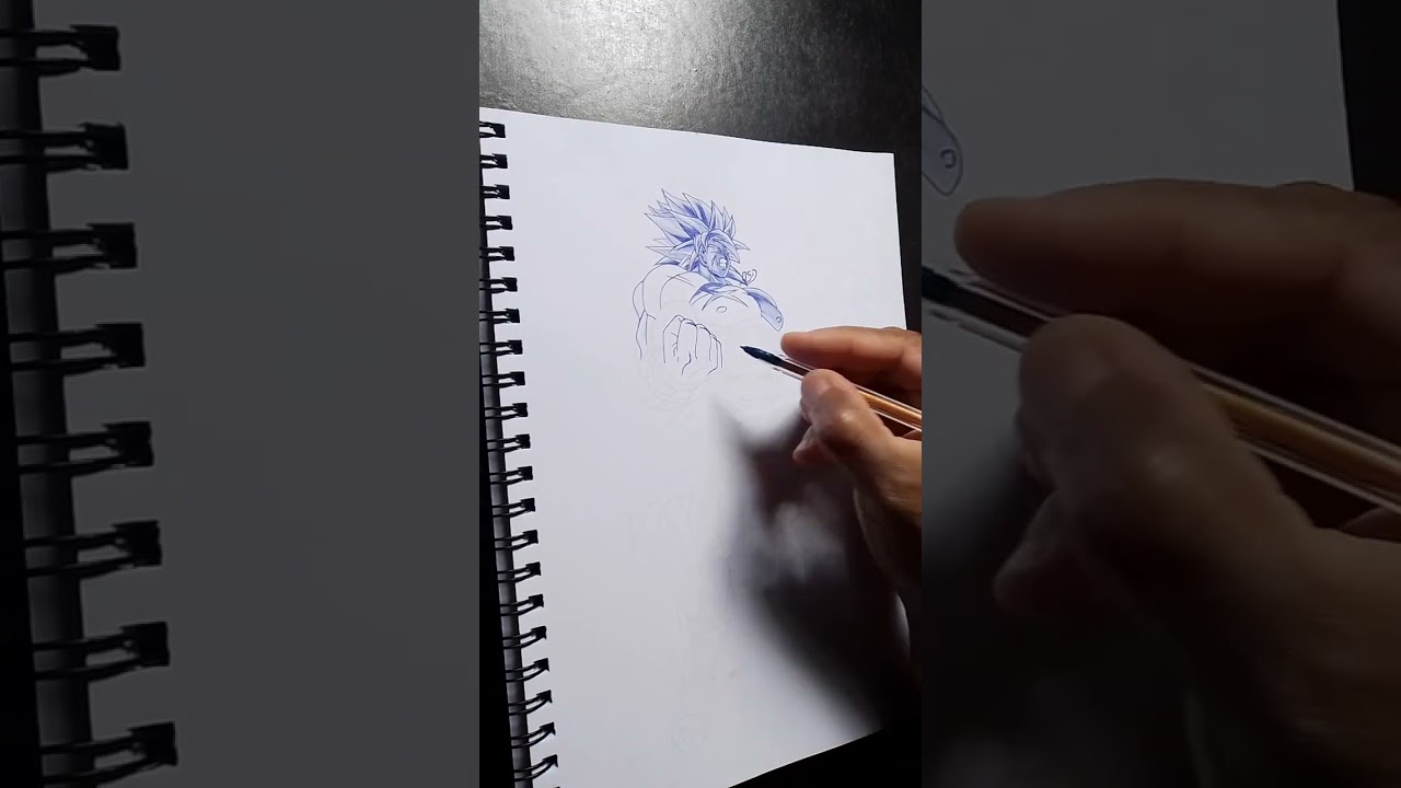 Desenho completo em Breve, Desenhando Broly, com caneta esferográfica preta.