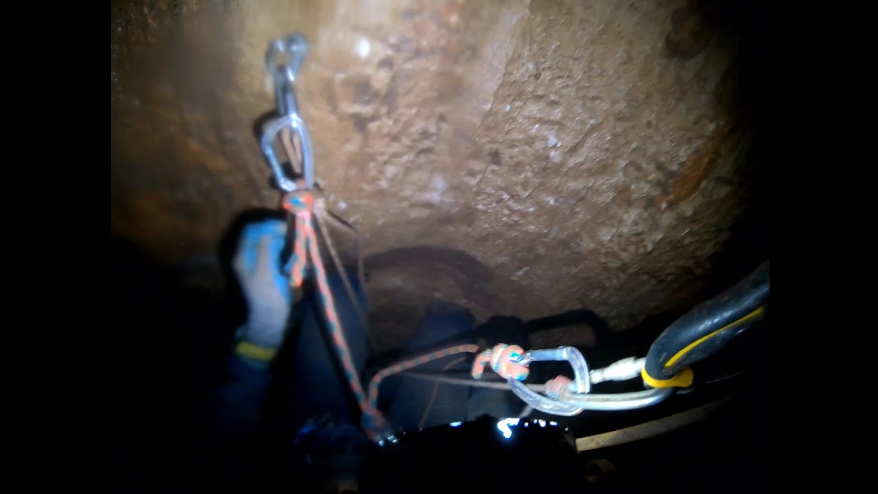 Passing Rebelays in a cave ascending and rappelling