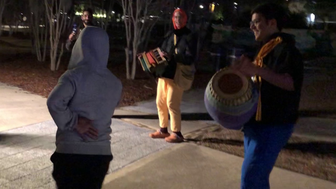 Krishna Kripa Das Chants Hare Krishna at First Friday in Tallahassee and a Passerby Dances
