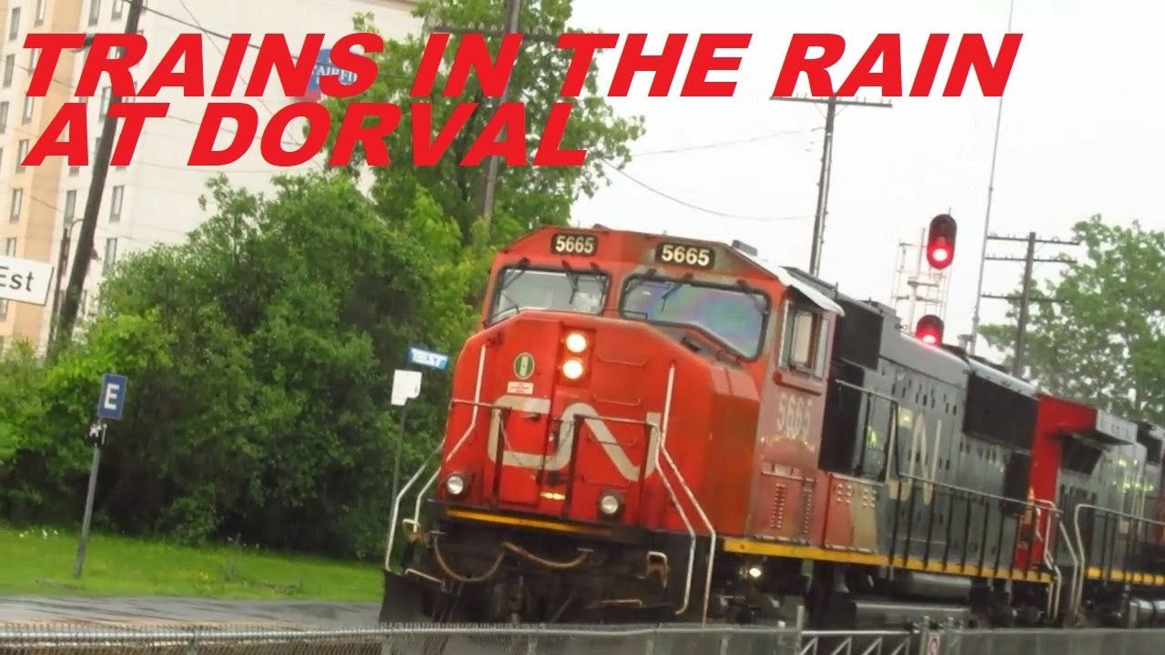 6 16 22 VIA TRAINS & A CN IN THE RAIN AT DORVAL STATION IN MONTREAL