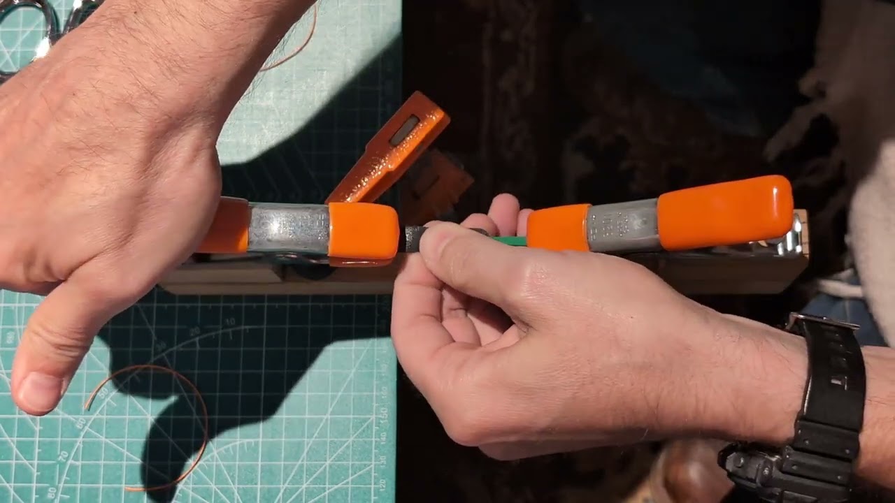 Attaching slingshot pouch to bands with constrictor knot.