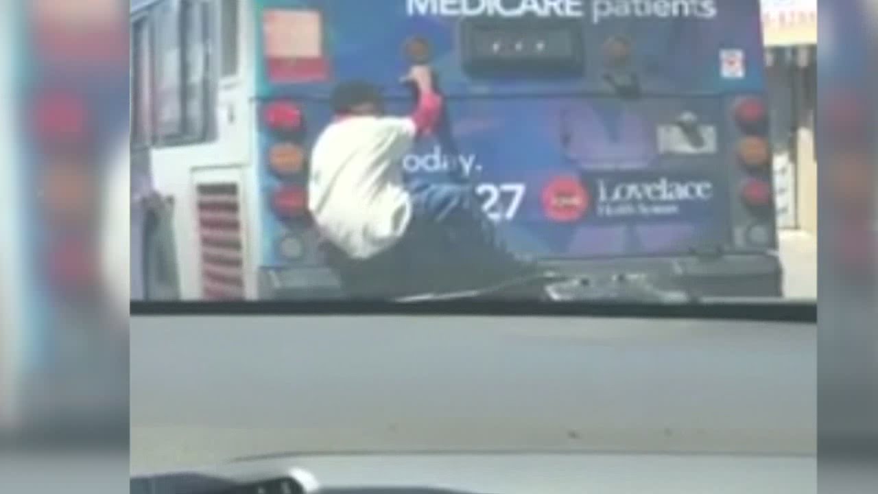 Video: Man seen catching a ride on the back of a city bus