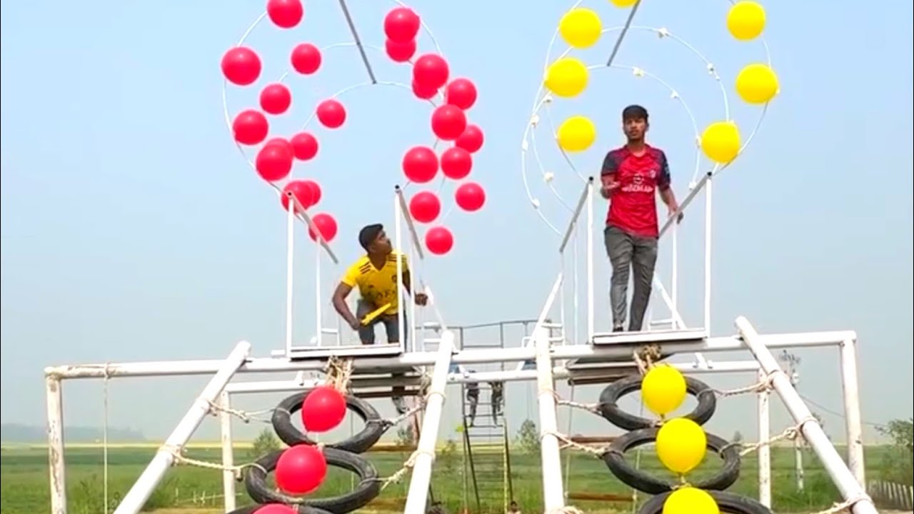 A wonderful competition between two people in a funny game of balloon bursting on tire stairs