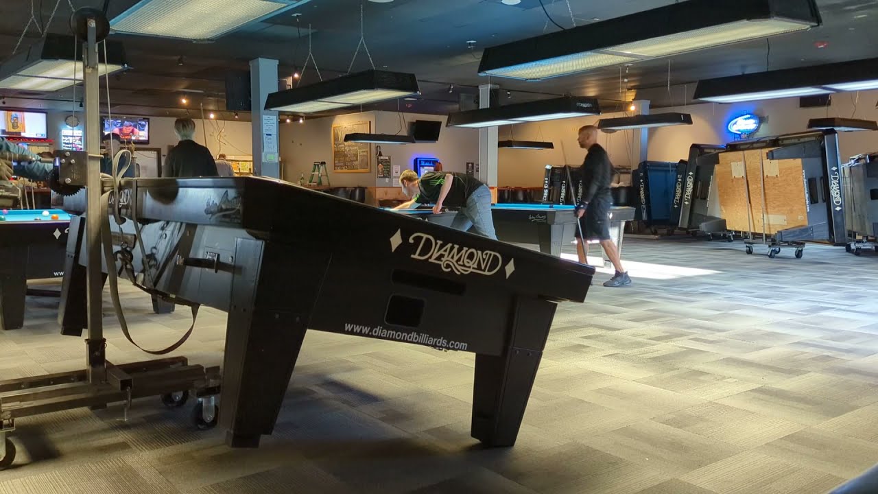 9' Diamond table flipping onto cart.