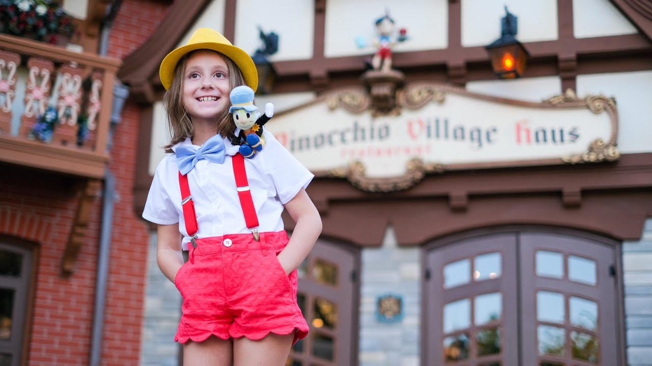 Jiminy Cricket sees little girl dressed as Pinocchio during The Festival of Fantasy parade at WDW