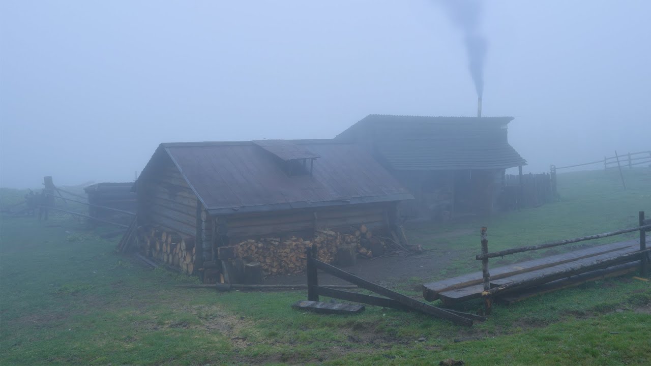 A night in an old abandoned log cabin in the mountains, Rain and thick fog