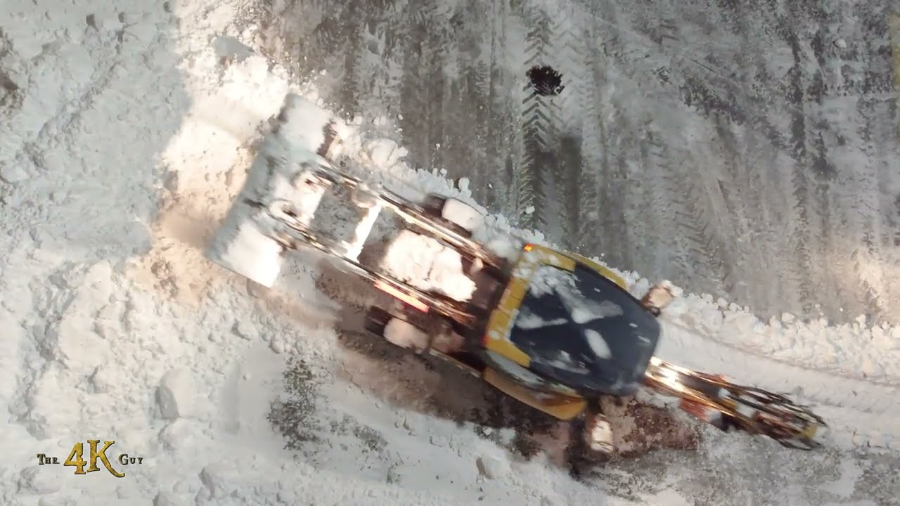 Snowplow Video 57 - Night time drone POV of snow clearing graders