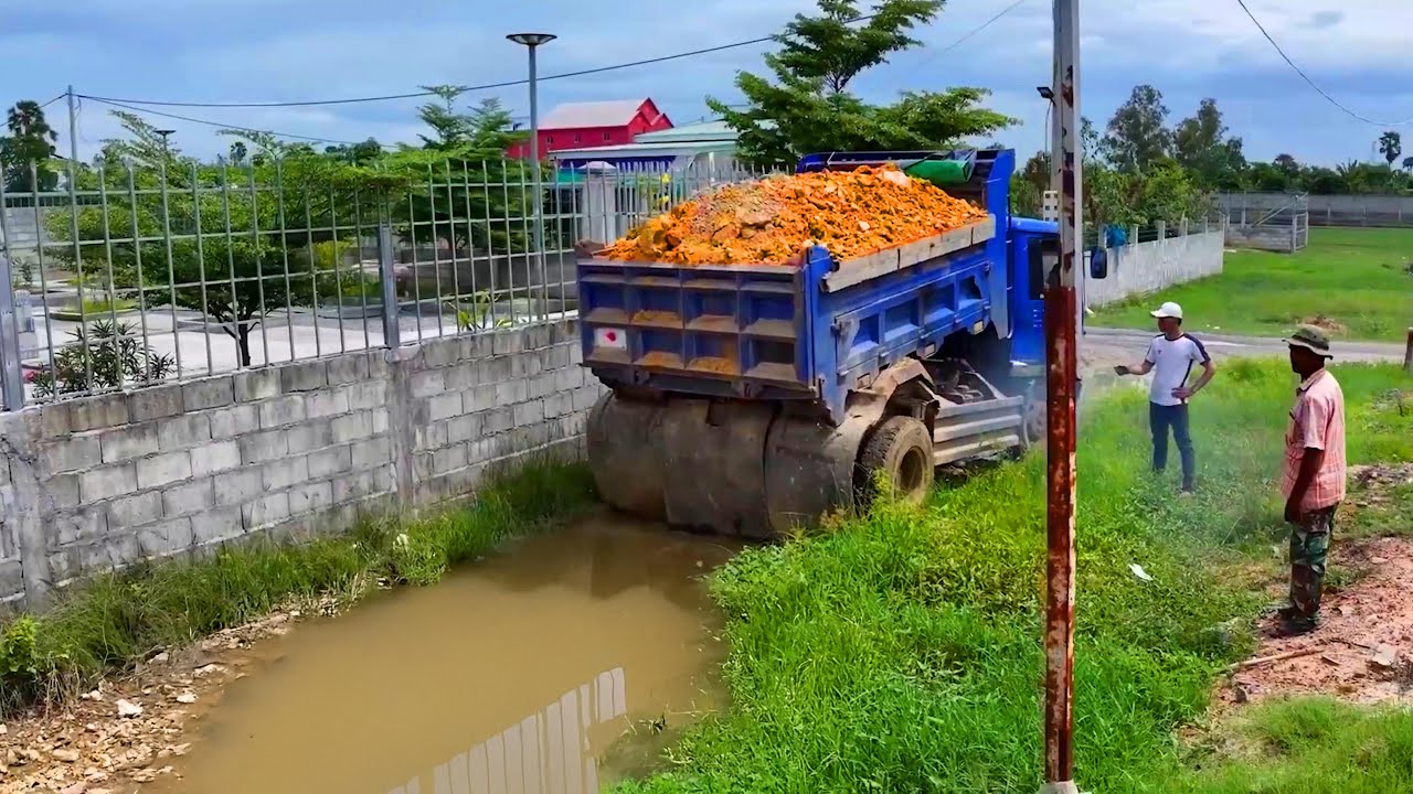 landfill complete project . truck transport soil , bulldozer push soil building house