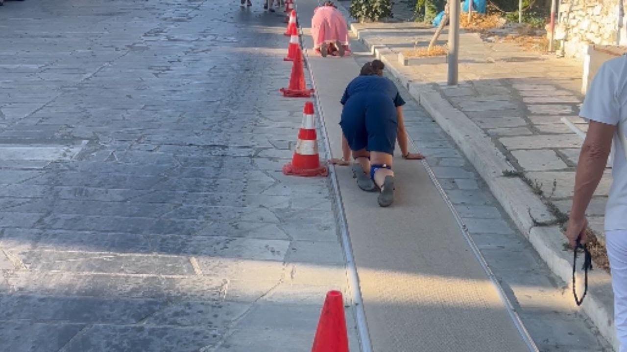 Tinos, Greece: Christians crawling up a carpeted hill in 40 degrees heat to reach church || WooGlobe