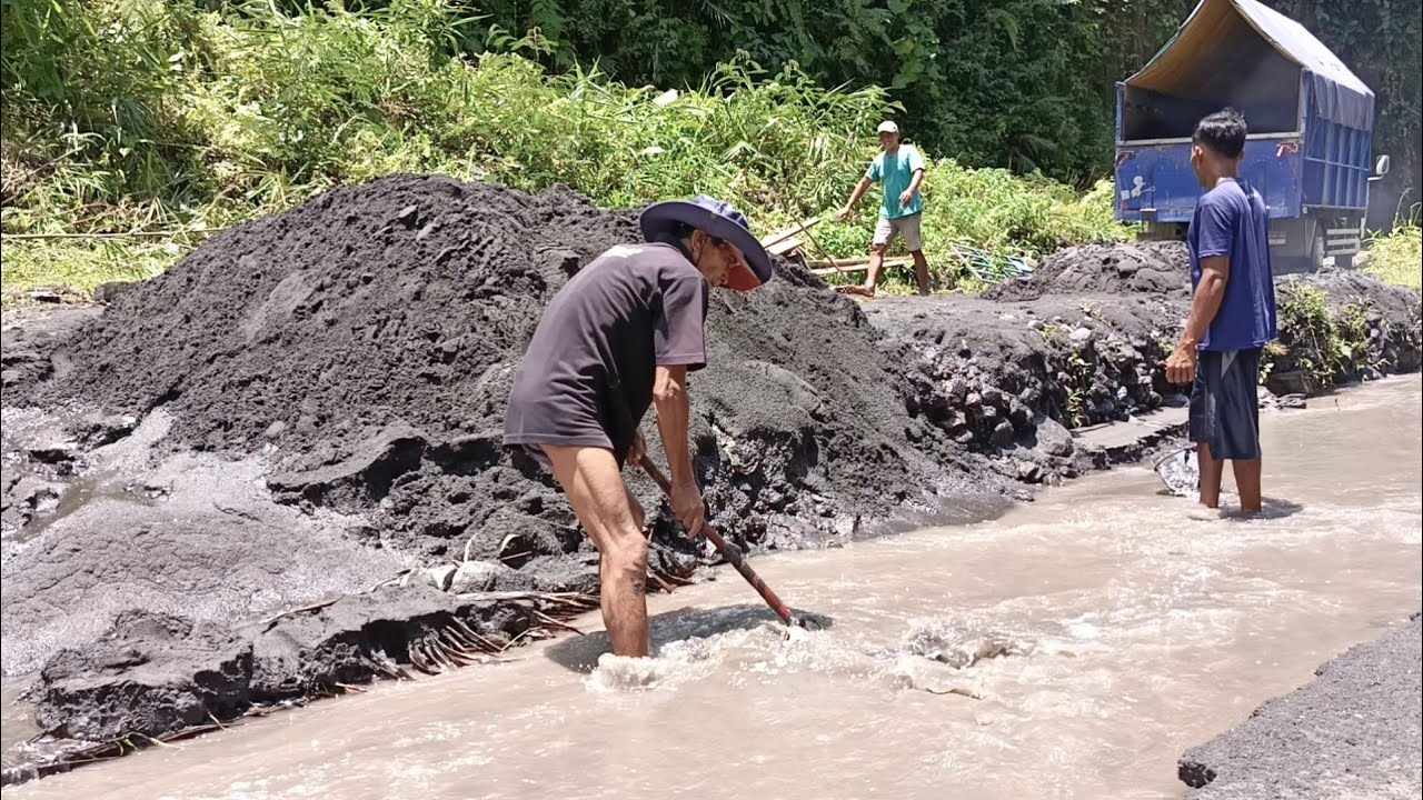 Collecting Sand To Load Into The Truck Bed