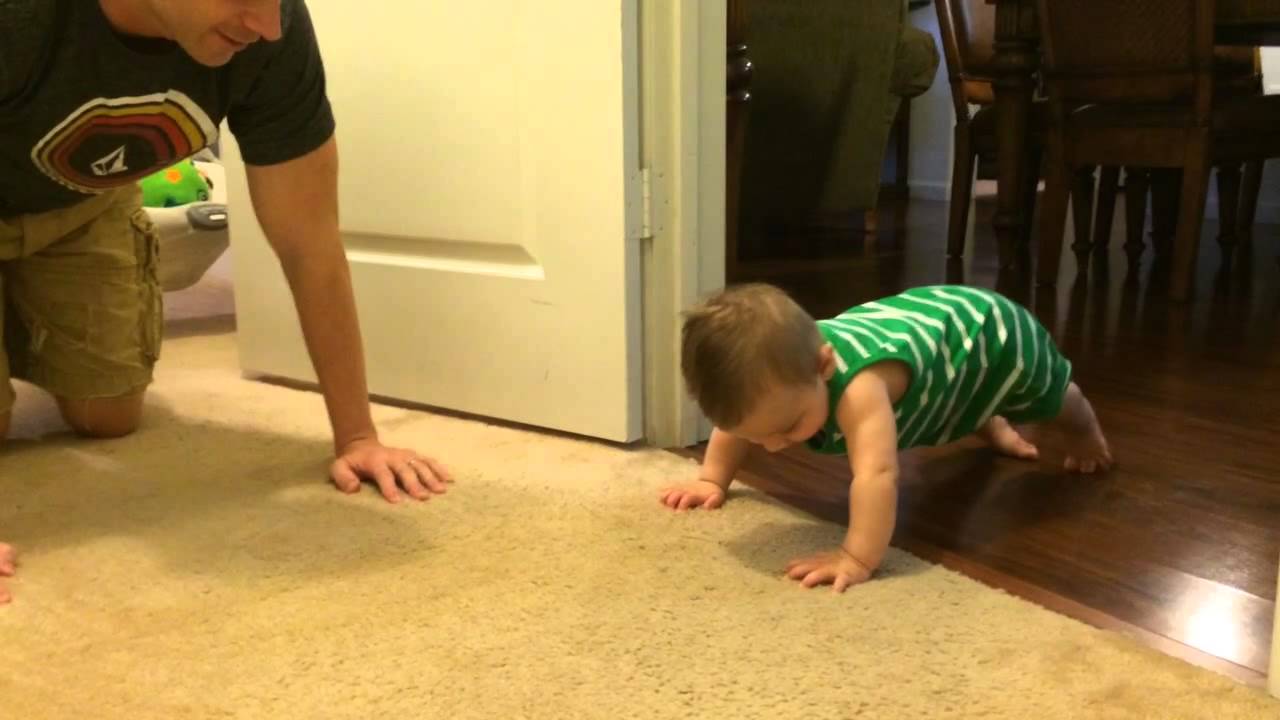 Baby doing push-ups with daddy