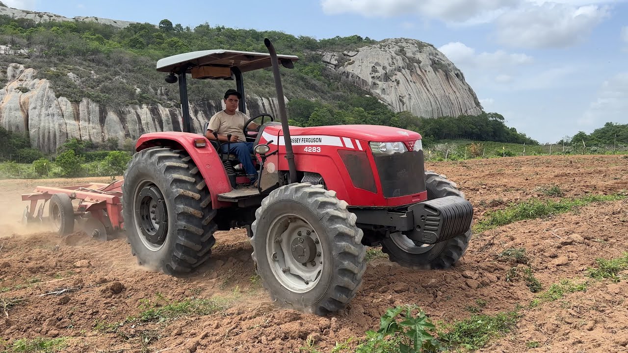 Traçadao gradeando a terra entre as rochas para o plantio de maracujá 