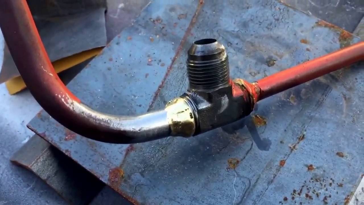 Brazing tractor hydraulic lines.