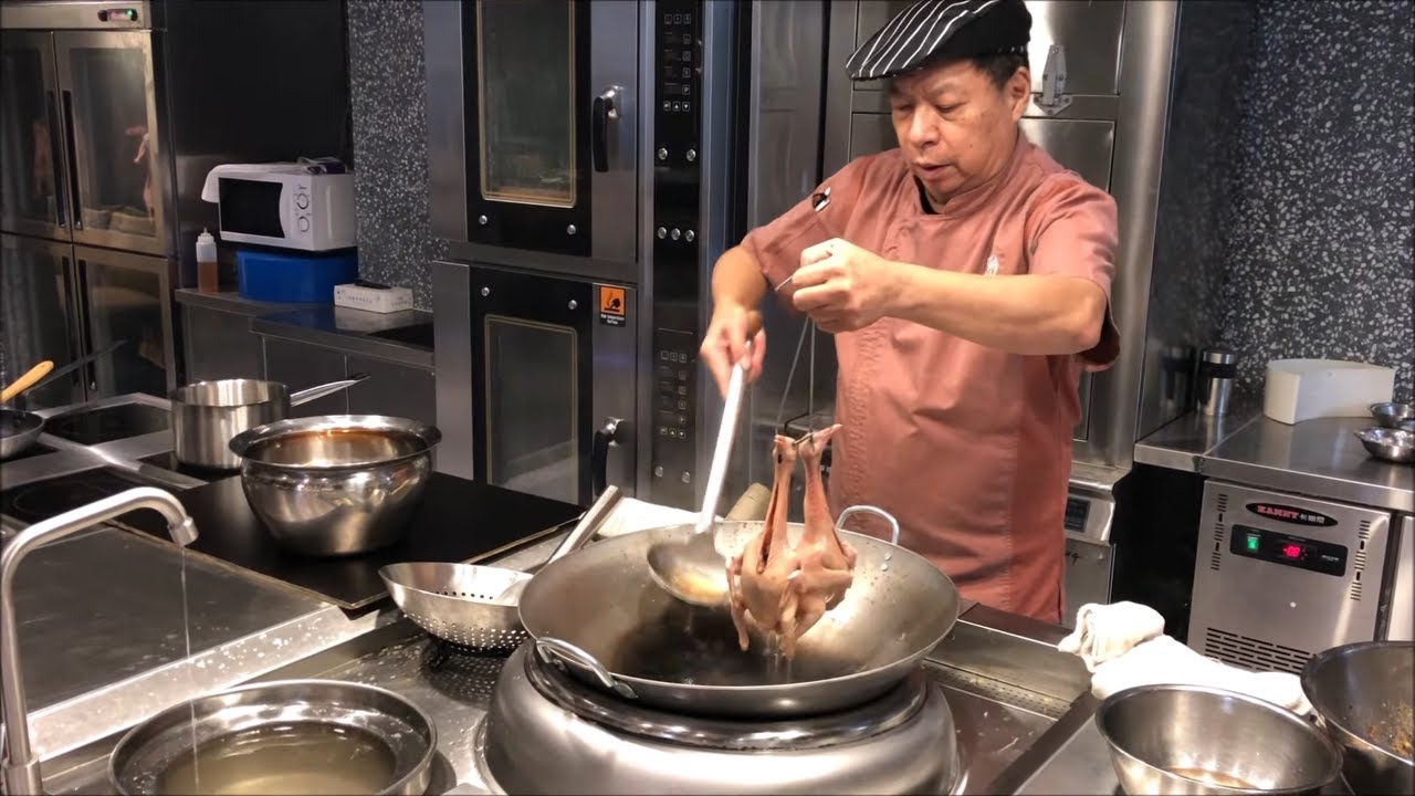 Chef Jian Chit Ming prepares his famous pigeon at 2 Michelin star Canton 8 in Shanghai, China