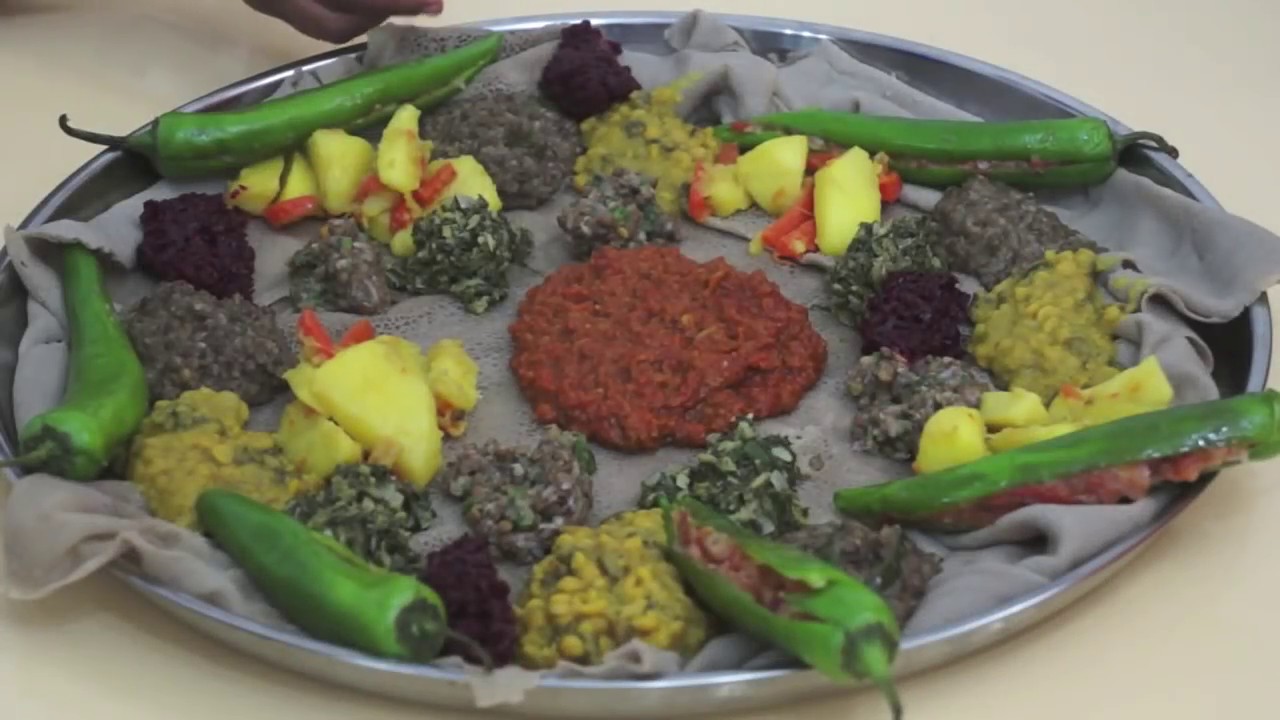 Ethiopian Food - Beyeyanetu a vegan platter of food on injera - miser - gomen - wot - enjera - sinig