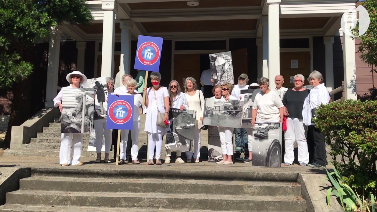 Parishioners protest during church service at St. Francis in Southeast Portland