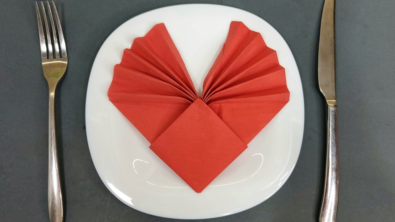 We make a red heart from a napkin on a plate Romantic table setting