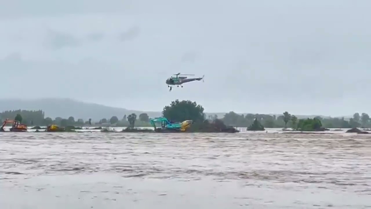 Indian Air Force CHETAK Helicopter crew rescuing people stuck in JCB