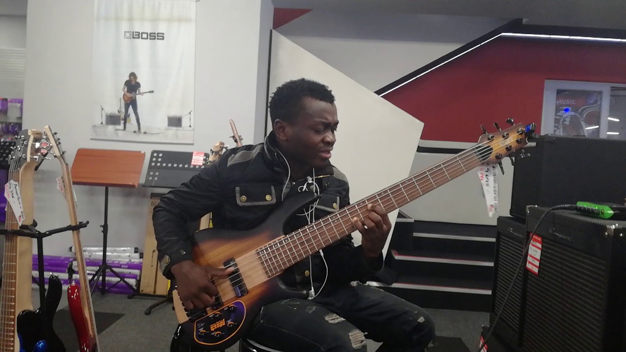Gracious on bass playing chords in music shop ... toms, vaccum  every where