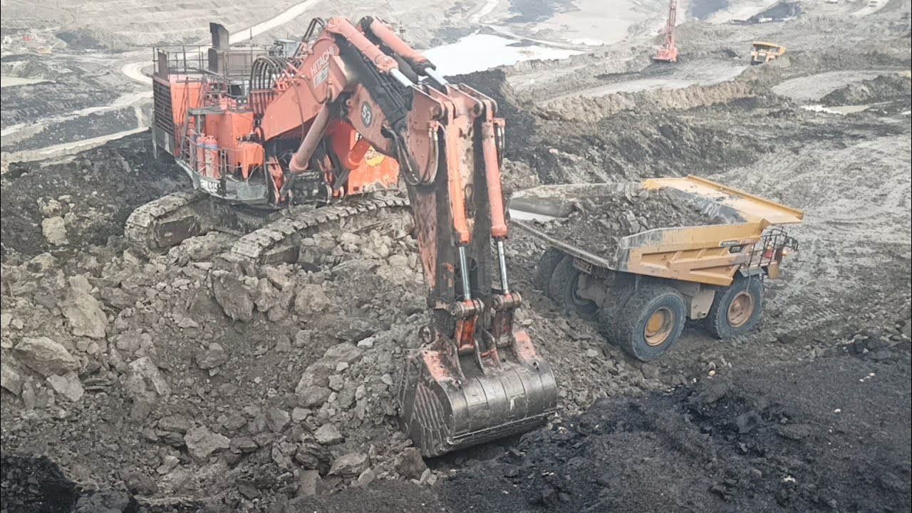Hitachi's EX2600 Loads Overburden Material into a Komatsu HD785 and Caterpillar OHT 777D