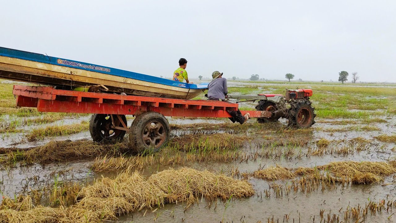 Driving tiny tractor to move the boat into the lake when the flood coming. Video in 4K