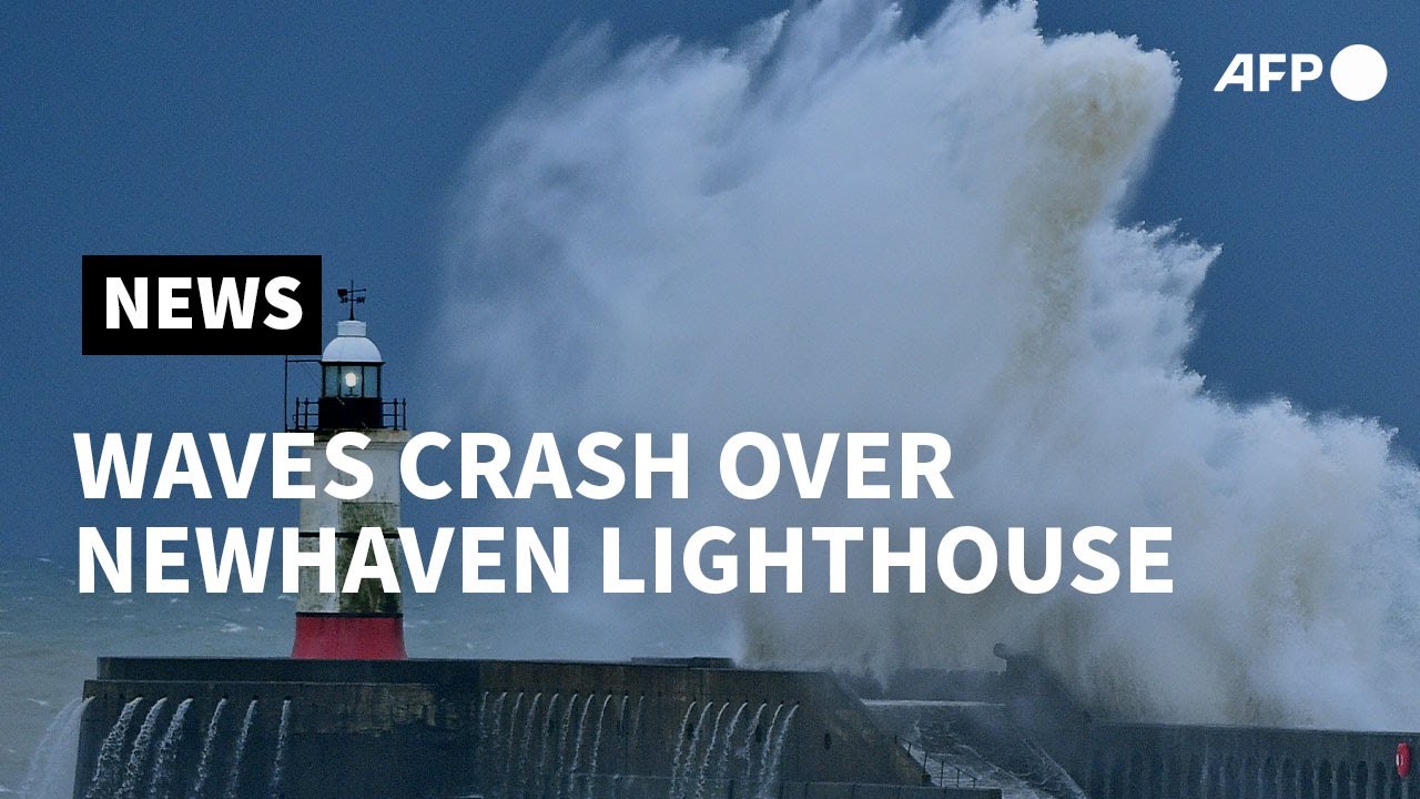 Waves crash over Newhaven Lighthouse as Storm Bella batters Britain | AFP