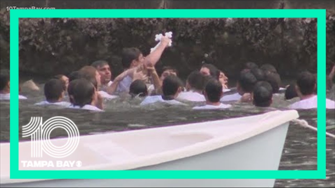 Divers head into Spring Bayou for Epiphany Celebration cross dive